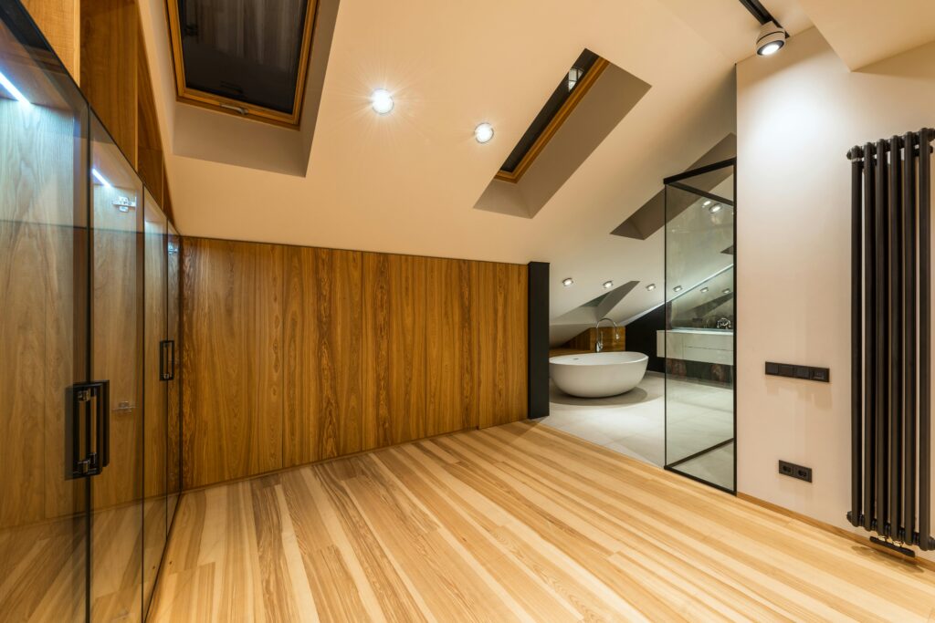 pexels photo 7045302 7045302 Creative design of bathroom with bath on floor under windows illuminated by lamps in house