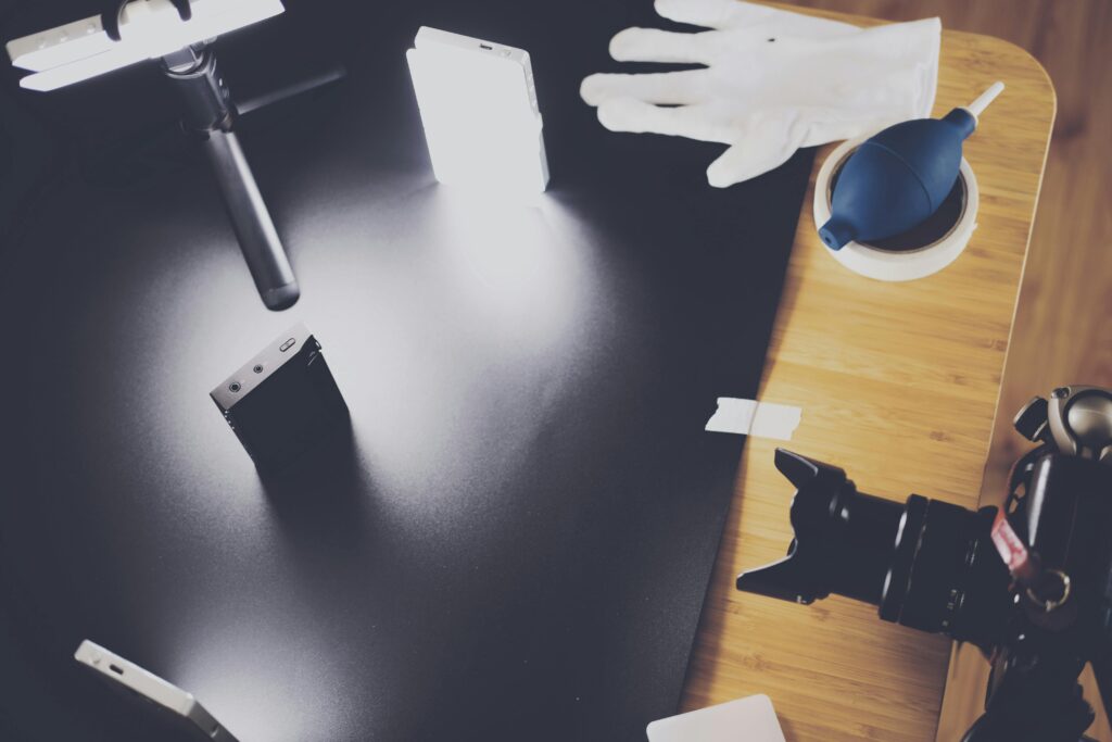 pexels photo 716273 716273 A photography setup with lighting equipment, camera, and accessories on a wooden table.