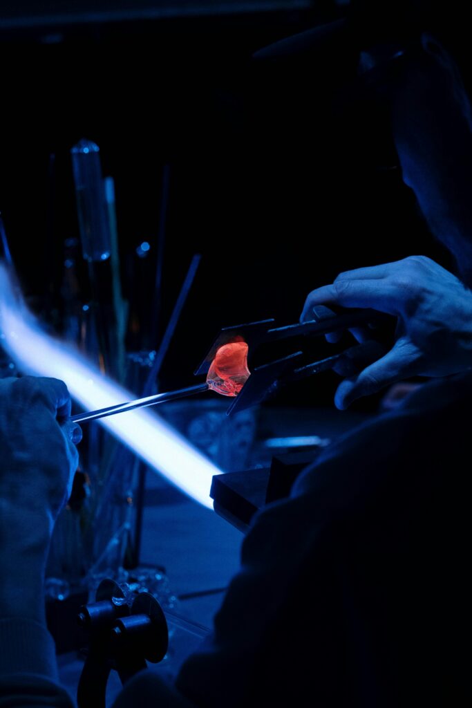 pexels photo 7519896 7519896 A skilled artisan performing glass blowing with a vibrant flame, creating intricate designs.