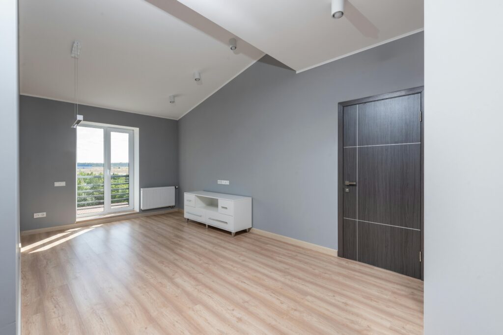 pexels photo 8146330 8146330 1 Bright and empty modern room with hardwood floors and large window view.